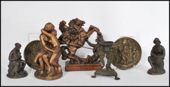 A collection of bronze and bronzed items to include a naked entwined couple, a Chinese incense