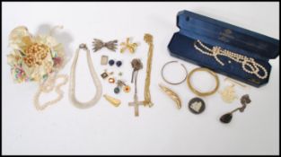 A group of vintage costume and silver jewellery to include pearl necklaces, white metal Cleopatra