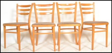 A set of four vintage retro 20th century beech 1960's utility dining chairs. Raised on tapered