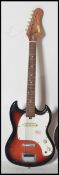 A vintage six string electric guitar by Arbiter having a burned body with white scratch guard and