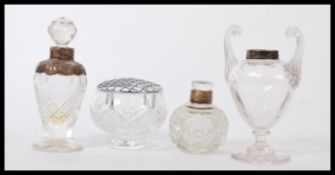 A selection of cut glass vanity dressing table items some having silver tops to include a small