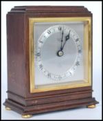 A vintage early 20th century Elliott mantel clock of square form having a silvered dial with Roman