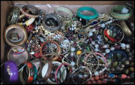 A large collection of vintage and contemporary costume jewellery to include bracelets beads,
