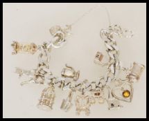 A 20th century silver hallmarked charm bracelet, w