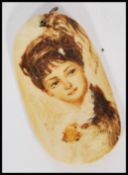 An early 20th century Marine Ivory Scrimshaw panel pendant having a painted portrait of a lady.