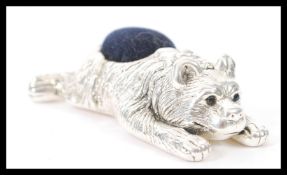 A stamped 925 silver pin cushion in the form of a bear having sapphire eyes, and a blue cushion to