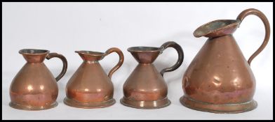 A group of four 19th century copper drinks measures liquid measures / jugs to include a City Of