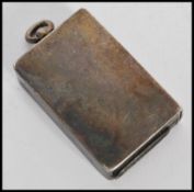 An early 20th century silver hallmarked sprung vesta case in the form of a matchbox with bale loop
