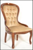 A 20th Century Victorian style spoon back mahogany framed button back upholstered nursing chair,