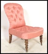 A 19th Century button backed mahogany  nursing chair having barley twist legs with brass casters,