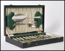 A cased set of silver plated cutlery consisting if twelve knives and forks with larger serving