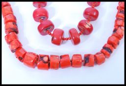 Two vintage large coral bead necklaces having graduating baroque coral beads with silver plated