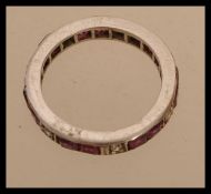 A white gold eternity ring set with square cut rubies and round cut diamonds. Size I.5. Weight 2.
