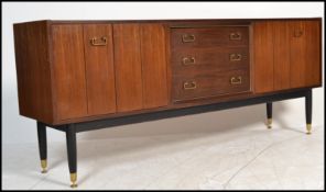A vintage mid 20th Century G - Plan E Gomme Tola sideboard / credenza, twin bi - fold doors flanking
