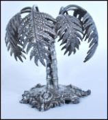 A 19th century Victorian silver plated centerpiece in the form of a palm tree raised on a scrolled