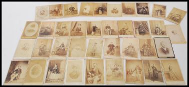 A collection of 19th century Victorian CDV portrait photographs held within a Sample photo box.