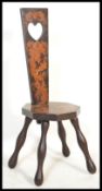 A 19th century Victorian mahogany inlay spinning chair having a pierced heart back and scrolled