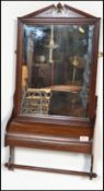 A Victorian 19th century mahogany wall mirror / towel rail having central mirror glass set over a