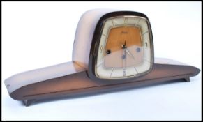 A vintage retro 20th century Anker mantel clock having an elongated body raised on angular feet.