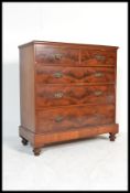 A late Victorian / Edwardian flame mahogany chest of drawers. Raised on a tall plinth base with