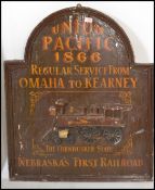 A 20th century wooden advertising sign being carved in relief and painted with notation and