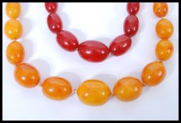 A vintage early 20th century hand knotted amber bead necklace having a barrel twist clasp. The