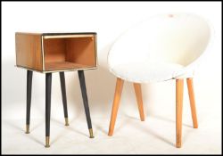 A retro mid century plastic satellite bedroom tub chair being raised on tapering legs together