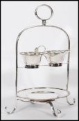 A late 19th century / early 20th century silver plated strawberry set and stand raised on scrolled