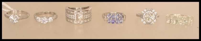 A selection of silver rings to include a stamped 925 band ring having lines of white stones with