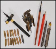 A group of vintage writing instruments to include two silver hallmarked pens one being a