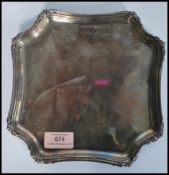 An early 20th century silver hallmarked salver tray of octagonal form having acanthus leaf borders