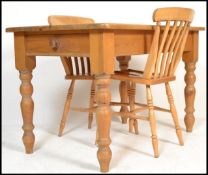 A 20th Century pine farmhouse dining table, pine top with single fitted drawer raised on shaped turn