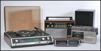 A group of vintage music items to include a Sharp Solid State Stereo Record Player and three