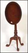 An antique style solid mahogany tilt top birdcage mechanism tripod wine table. The circular table