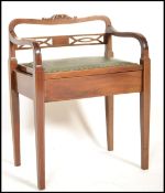 An Edwardian mahogany and leather piano stool chair being raised on squared inlaid legs with