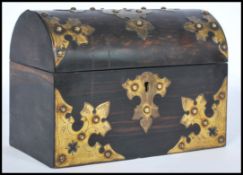 A 19th century coromandel wood dome work box having large armorial brass mounts to the domed lid and