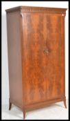 A mid century Maple Co flame mahogany double wardrobe. Raised on bracket feet with twin full