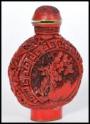 A 20th century Chinese Cinnabar Lacquer perfume bottle having floral decoration with Greek key