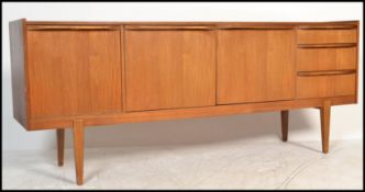 A retro 20th Century teak wood sideboard / credenza, three cupboards with a run of three drawers