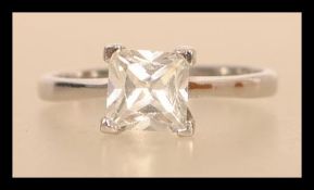A hallmarked 9ct white gold engagement solitaire ring having a large square cut white stone.