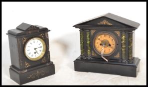 A 20th century slate mantel clock with with a central round enamelled face with roman numerals to