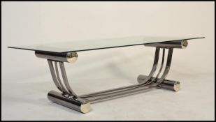 A contemporary 20th century glass and chrome coffee - occasional table. The chrome tubular base of