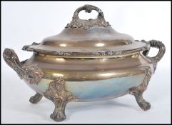 A late 19th Century silver plated lidded terrine in the Rococo taste, raised on four scrolled feet