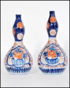 A pair of 19th century Japanese Imari gourd vases having hand painted decoration. Measures 20cm-high