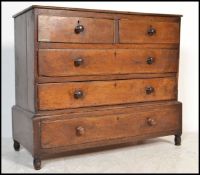 An 18th century country oak chest of drawers on stand. Raised on flared breakfront plinth drawer