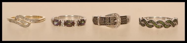 A selection of silver and white metal rings to include a stamped 925 buckle ring with inset black