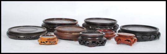 A group of vintage Chinese hardwood vase stands dating from the 19th century of various forms and