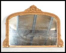 A 19th century large overmantel mirror having a bevelled mirror panel with large gilt ormolu
