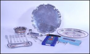 A group of silver plate to include two large salver trays, silver plated and oak wine coaster,