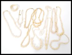 A selection of carved bone jewellery to include carved necklaces including elephants and flowers and
